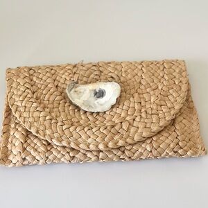 Woven clutch with oyster accent